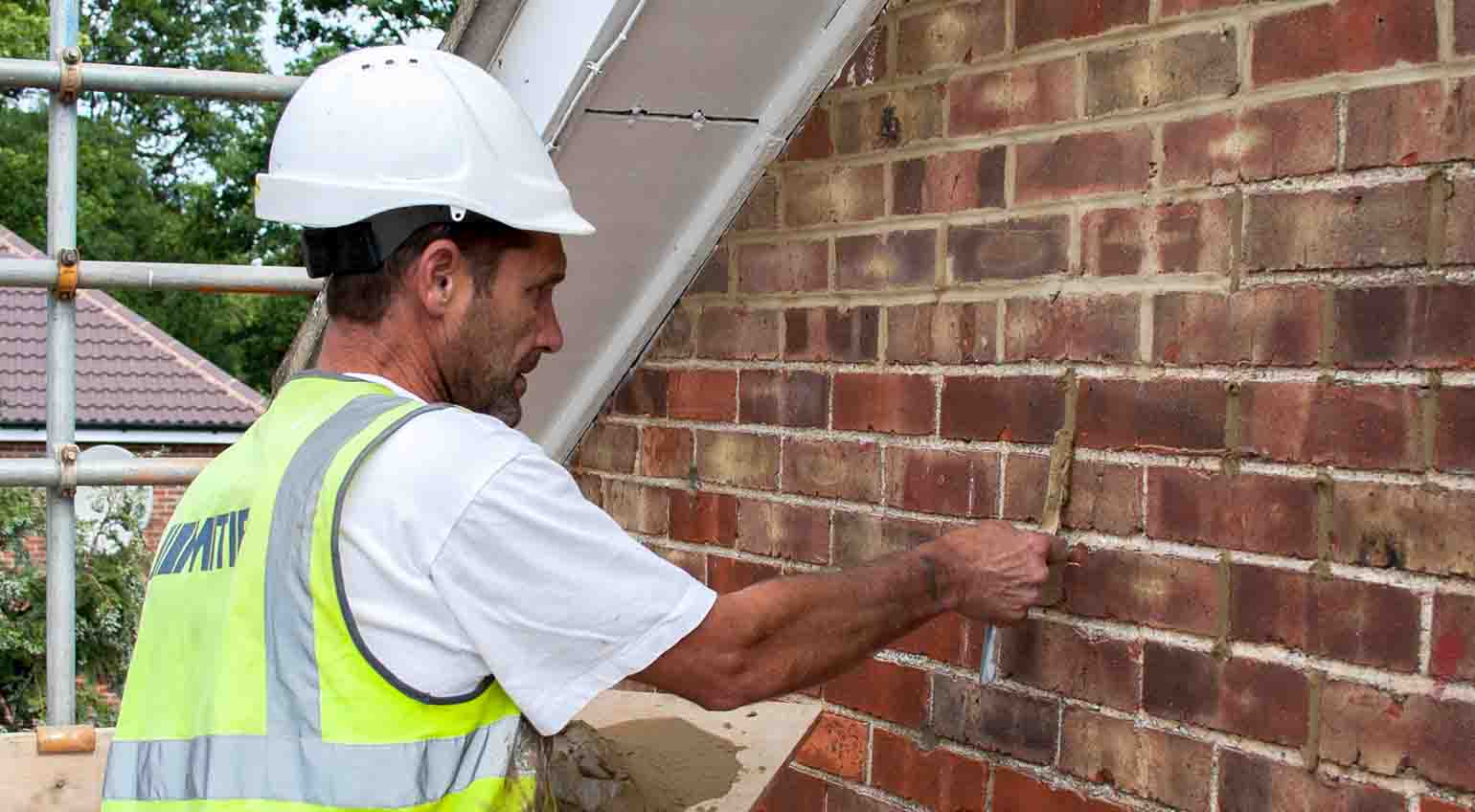 Gable end of a house being repointed with Stormdry repointing additives