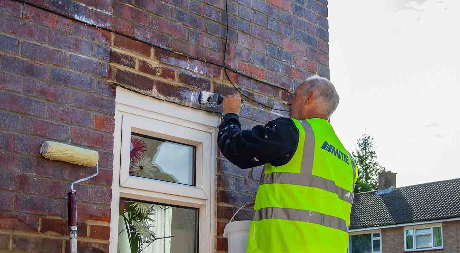 Stormdry being applied with a brush to treat porous bricks